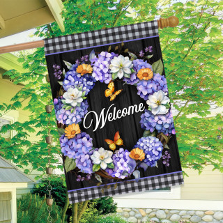 Hydrangea wreath house flag with purple, white, and yellow flowers and welcome text on black background.