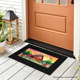 American Barn Mini Mat, black border, colorful barn design, on a wooden porch in front door.