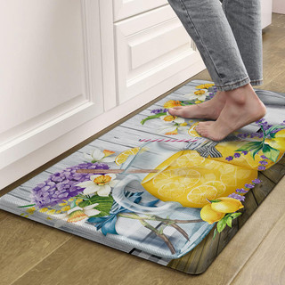 Lemonade Comfort Mat with floral design and lemon pattern in yellow and purple hues on floor.