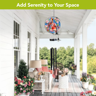 Cherry Blossom Cardinal Illuminated Wind Chime hanging from a porch ceiling surrounded by flowers.