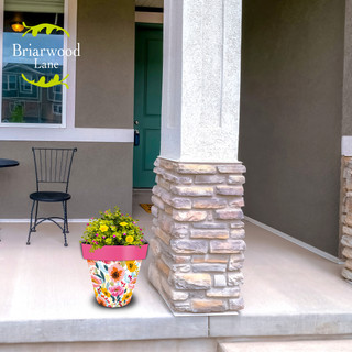 Vibrant Blooms Medium Planter with yellow flowers and colorful floral design on a front porch.