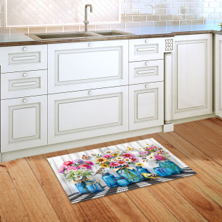 Blue Jar Bouquets colorful doormat with flower design on wooden kitchen floor beside white cabinets.