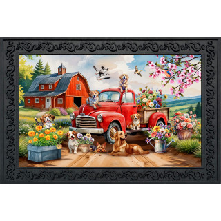 Farm Pups Doormat with red truck, dogs, flowers, and barn in a black frame design.