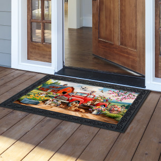 Farm Pups doormat with colorful dog and wagon design on wooden porch with black border.