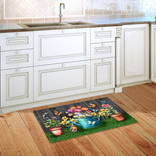 Garden Buddies doormat on wooden floor with colorful floral and butterfly design in a kitchen setting.
