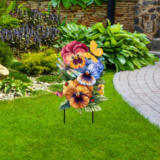 Colorful metal art piece featuring Pansy Trio flowers in garden setting on metal stand outdoors.