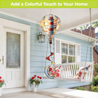 Lighthouse At Sunset Hot Air Balloon Spinner, colorful stained glass decoration hanging from a porch ceiling.