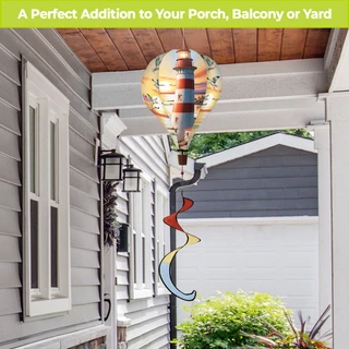 Lighthouse At Sunset hot air balloon spinner outdoor decor with colorful swirls on a porch.