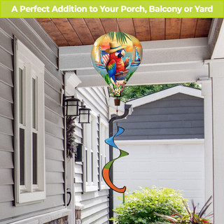 Happy Hour Parrot Hot Air Balloon Spinner with vibrant parrot design and colorful spiral tail outdoors.