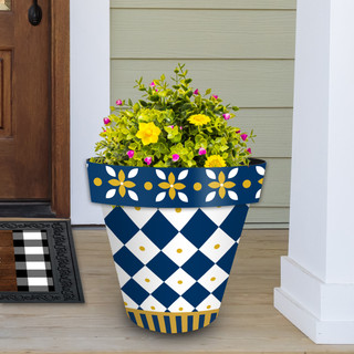 Large blue and gold planter with white diamond pattern and flowers, filled with greenery and blooms.