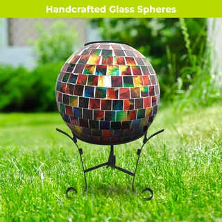 Multicolor solar LED glass gazing ball on a stand, mosaic tiles reflecting various colors outdoors.