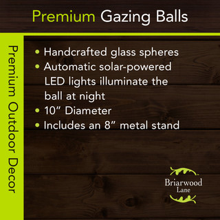 Organic purple and green solar LED glass gazing ball with metal stand, handcrafted and illuminated at night.
