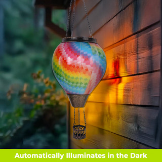 Colorful Patchwork Solar Balloon Lantern with vibrant rainbow hues and tassel hanging from chain outdoors.