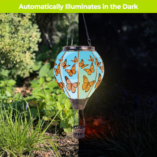 Butterflies Solar Balloon Lantern with orange butterflies on a blue background hanging outdoors.
