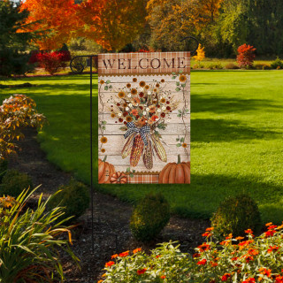 Autumn Corn Garden Flag with Welcome message, featuring pumpkins and fall flowers on a garden lawn.