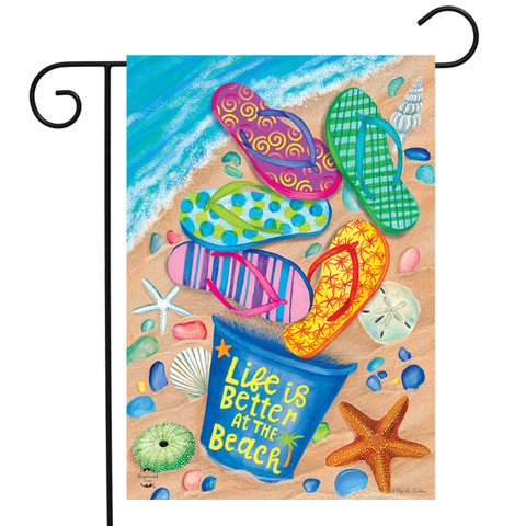 Briarwood Lane Better At The Beach garden flag with colorful flip flops on sandy ocean shore.