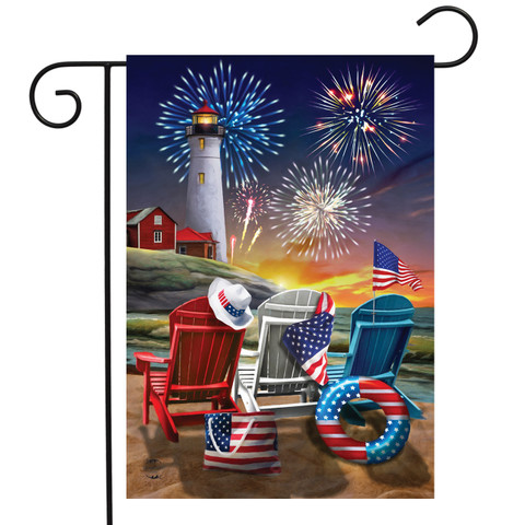 Briarwood Lane Beachfront Fireworks garden flag with patriotic lighthouse, stars, stripes on shore by ocean.