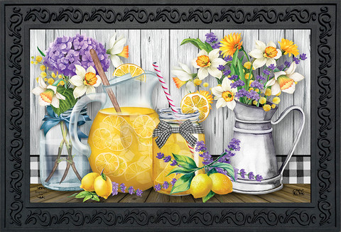 Briarwood Lane Lemonade Summer Doormat with floral design and pitcher on a wooden surface outdoors.