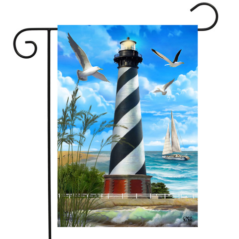 Briarwood Lane Hatteras Lighthouse garden flag with nautical shoreline scene and sailboat under blue sky.