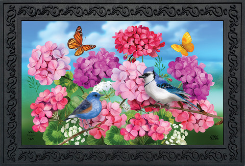 Briarwood Lane Geraniums In Bloom Spring Doormat with colorful flowers, butterflies, and birds on decorative mat.
