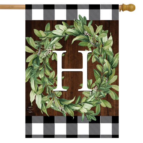 Briarwood Lane monogrammed house flag with greenery wreath on plaid background for farmhouse porch decor.