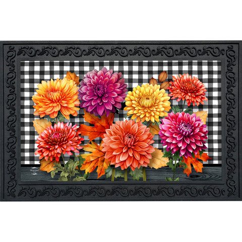 Vibrant orange, pink, and yellow mums on black and white checkered doormat with decorative border.