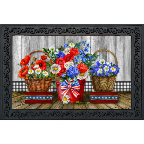 Vibrant floral arrangement in baskets and vase with red, white, and blue flowers on wooden floor.
