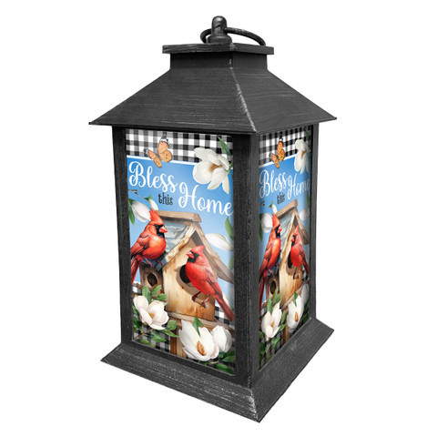 Black Bless This Home Cardinal Lantern with red cardinals, flowers, and blue background.