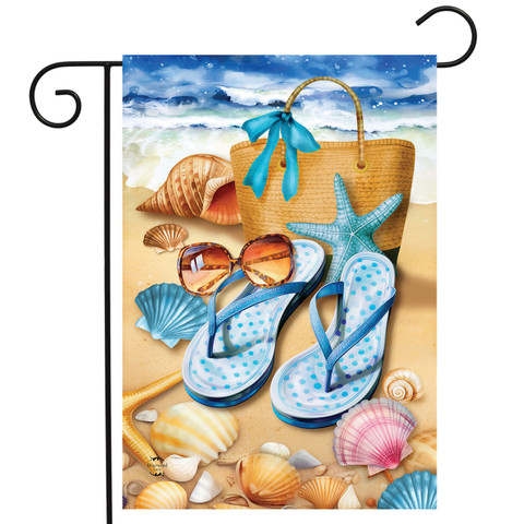 Welcome To the Beach Flip Flop Garden Flag with seashells and starfish on sandy beach.