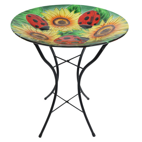 Ladybugs and Sunflowers design on a round glass birdbath with black wrought iron stand base.