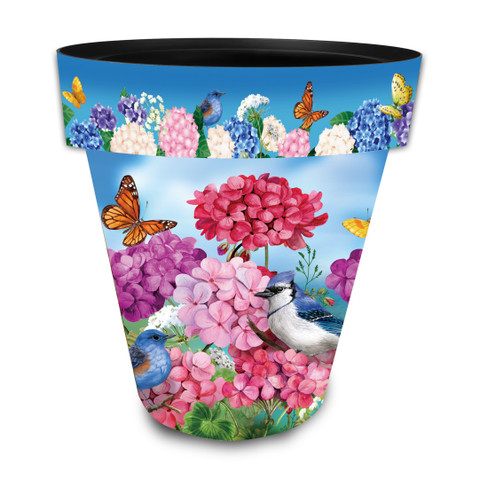 Large colorful planter with pink, purple flowers, butterflies, and birds, blue sky background, Geraniums in Bloom.