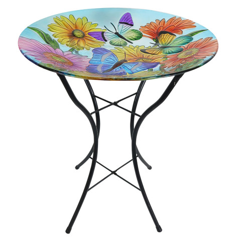 Round glass birdbath table with colorful butterfly and flower design on black metal stand base.