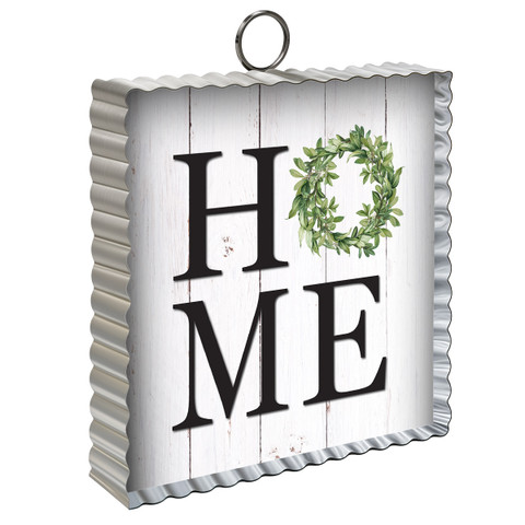 Home Metal Mini Moment sign with white wood grain, green wreath, and black lettering, silver metal frame.