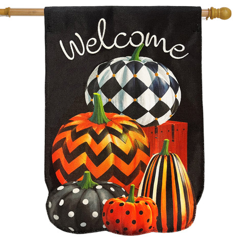 Black burlap house flag with welcome and stacked patterned pumpkins in orange, black, and white.