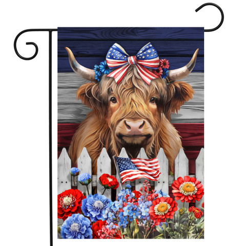 Patriotic Highland Cow Garden Flag with American flag flowers and bow on cow's head outdoors.