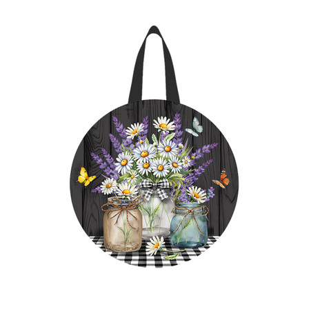 Lavender and Daisies floral design on a black circular tote bag with handles.