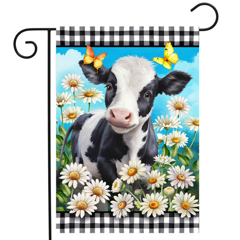 Black and white cow surrounded by white daisies and butterflies on checkered garden flag.