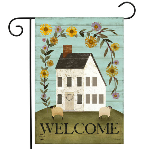 Country Saltbox Garden Flag with white house, colorful flowers, sheep, and welcome text on green hill.