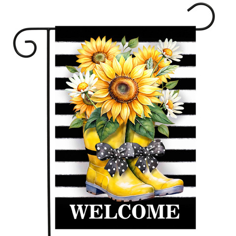 Yellow rain boots with gray bow and sunflowers on black striped garden flag with welcome text.