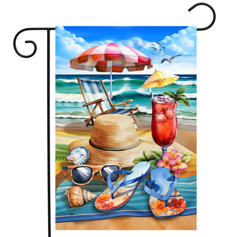 Beach Day Garden Flag with beach scene, umbrella, chair, hat, sunglasses, and tropical drink on towel.