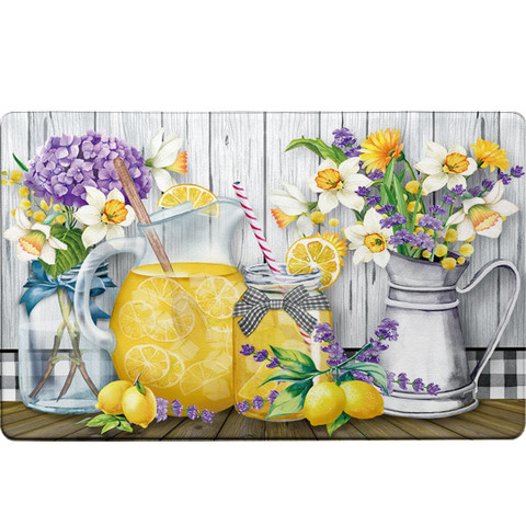 Lemonade Comfort Mat with floral design, lemons, and pitcher on wooden table with white background.