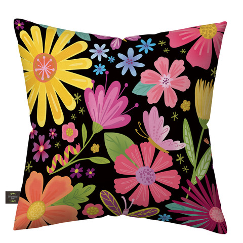 Vibrant floral pillow with pink, yellow, orange, and blue flowers on a black background.
