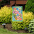 Briarwood Lane small printed garden flag with colorful beach scene and seashells on sand background.