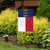 Briarwood Lane small printed North Carolina garden flag displayed on lawn with colorful decorative design.
