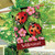 Briarwood Lane ladybugs on leaves spring house flag with pink flowers and welcome sign displayed outdoors.