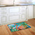 Briarwood Lane Flamingo Paradise Summer Doormat on kitchen floor with vibrant tropical colorful design.