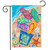 Briarwood Lane Better At The Beach garden flag with colorful flip flops on sandy ocean shore.