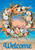 Briarwood Lane Driftwood Wreath Summer House Flag with colorful shells and welcome on sandy beach.