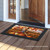 Briarwood Lane Autumn Scarecrow Harvest Doormat with black border and vibrant fall pumpkin design on wooden porch.