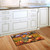 Briarwood Lane small printed Pumpkin Farm Fall Doormat with colorful autumn harvest design on kitchen floor.